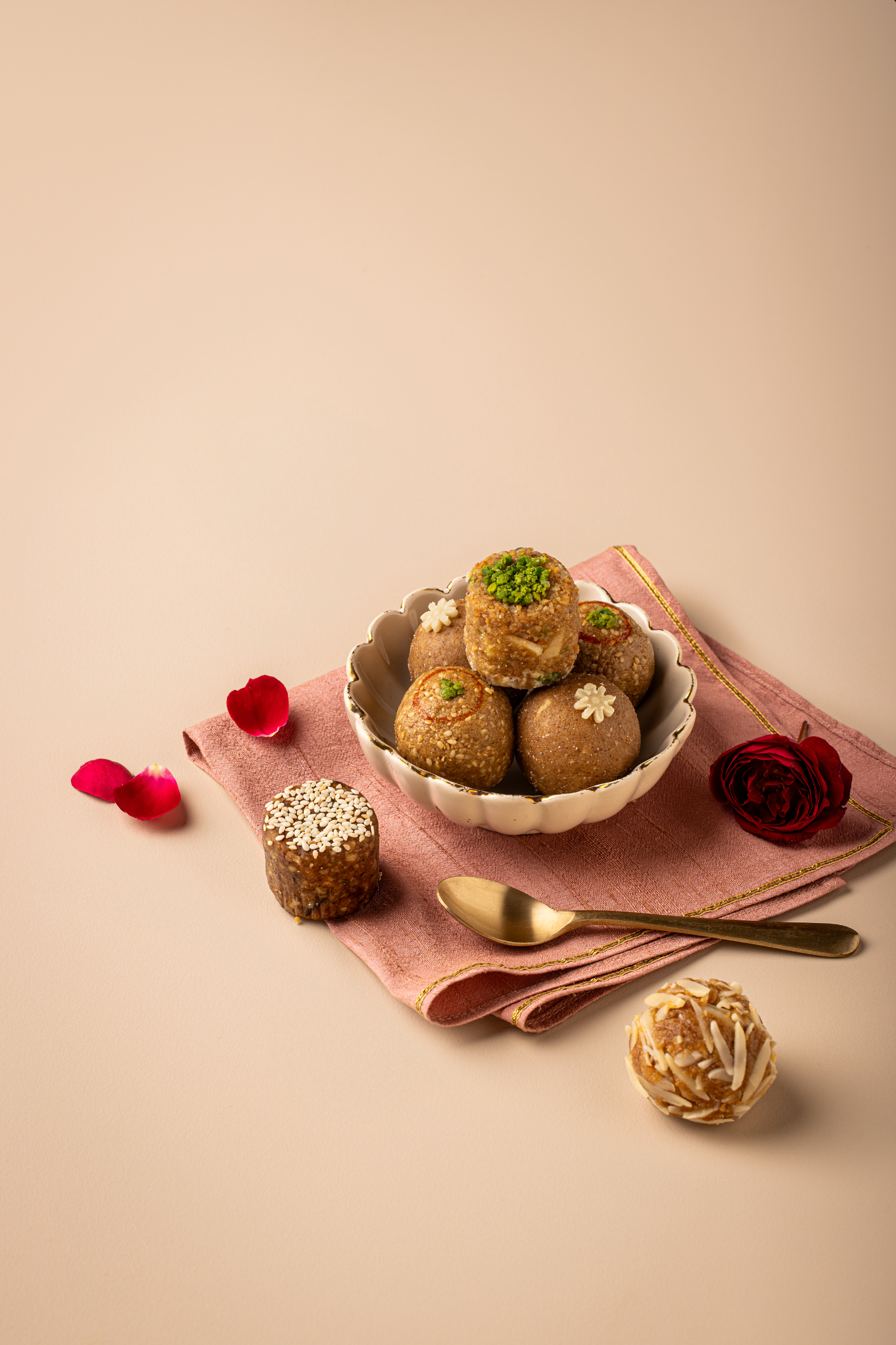 TLW Jodha Box inspired by Rajput princess Jodha Bai, featuring an assorted royal laddoo collection including Til Gur, Atta Panjiri, TLW Nuts, Dates & Walnuts, and Mewari Churma laddoos in an elegant premium gift box.