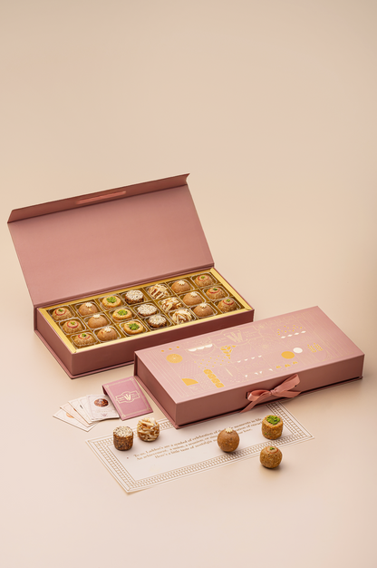 TLW Jodha Box inspired by Rajput princess Jodha Bai, featuring an assorted royal laddoo collection including Til Gur, Atta Panjiri, TLW Nuts, Dates & Walnuts, and Mewari Churma laddoos in an elegant premium gift box.